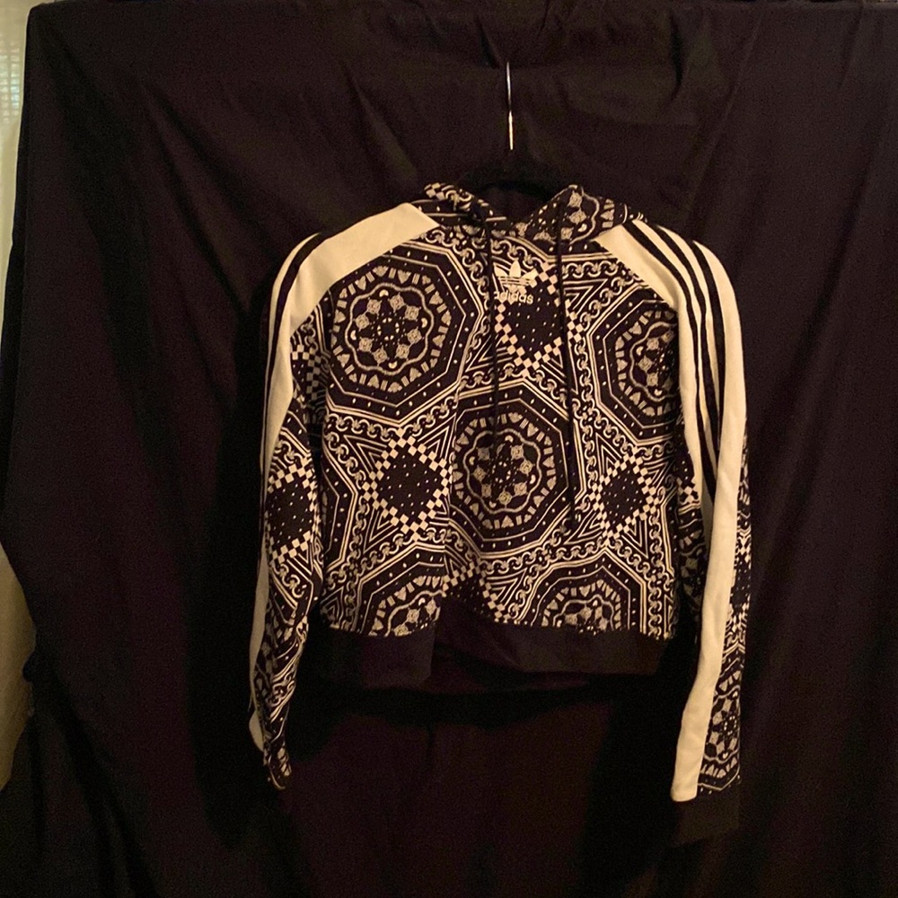 This is a multicolored Adidas cropped sweatshirt size small.
